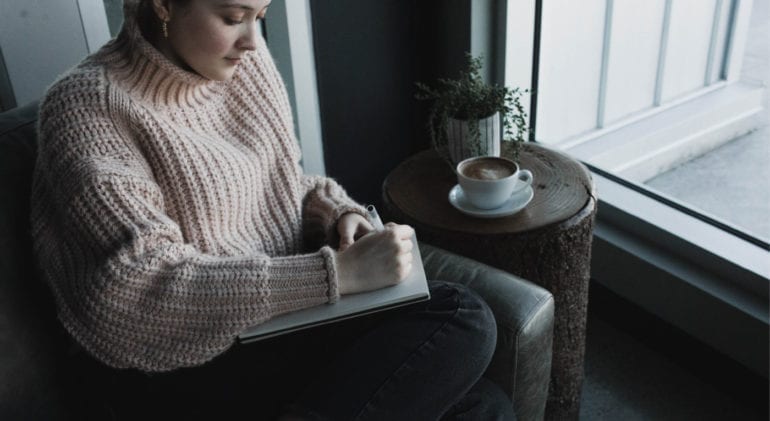 woman writing in journal