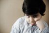 Sad child, struggling during pandemic, seeking comfort.