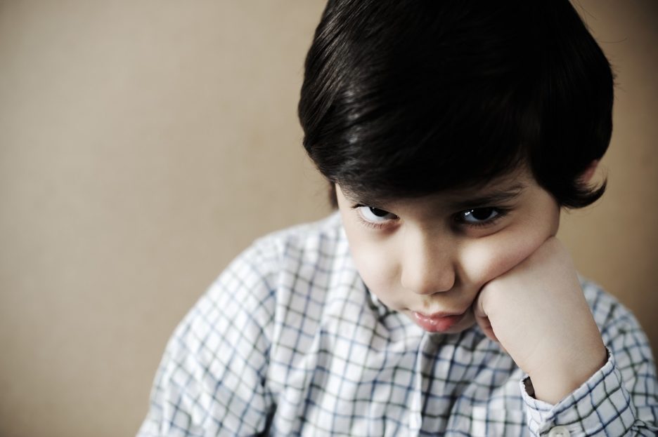 Sad child, struggling during pandemic, seeking comfort.