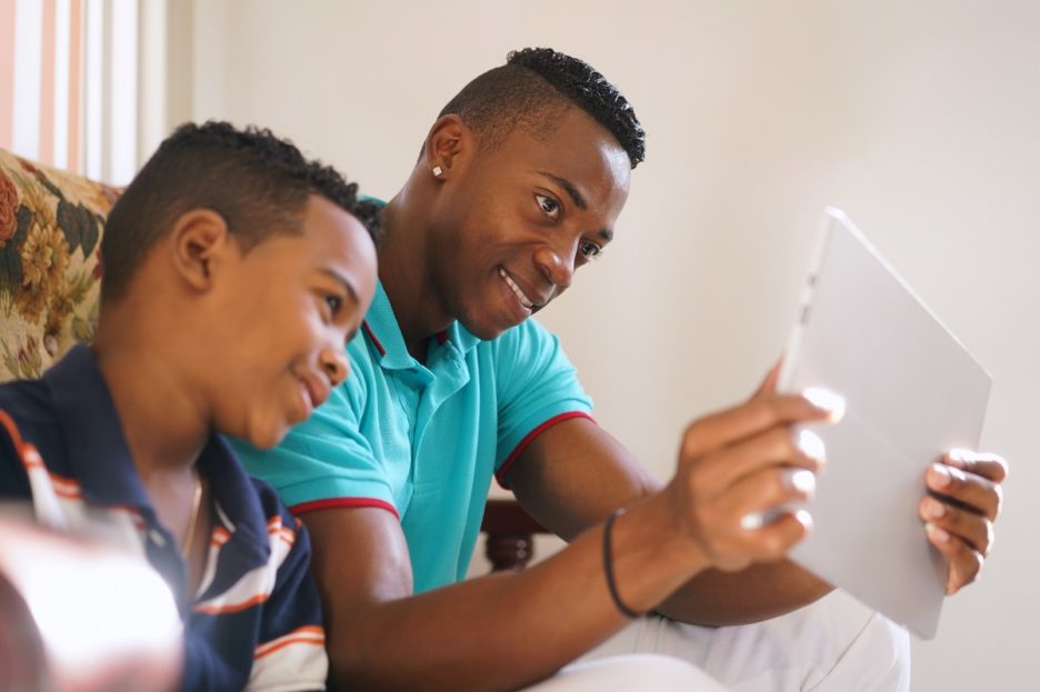 Father and son with tablet