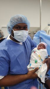 Frankie Wilson holding his newborn son