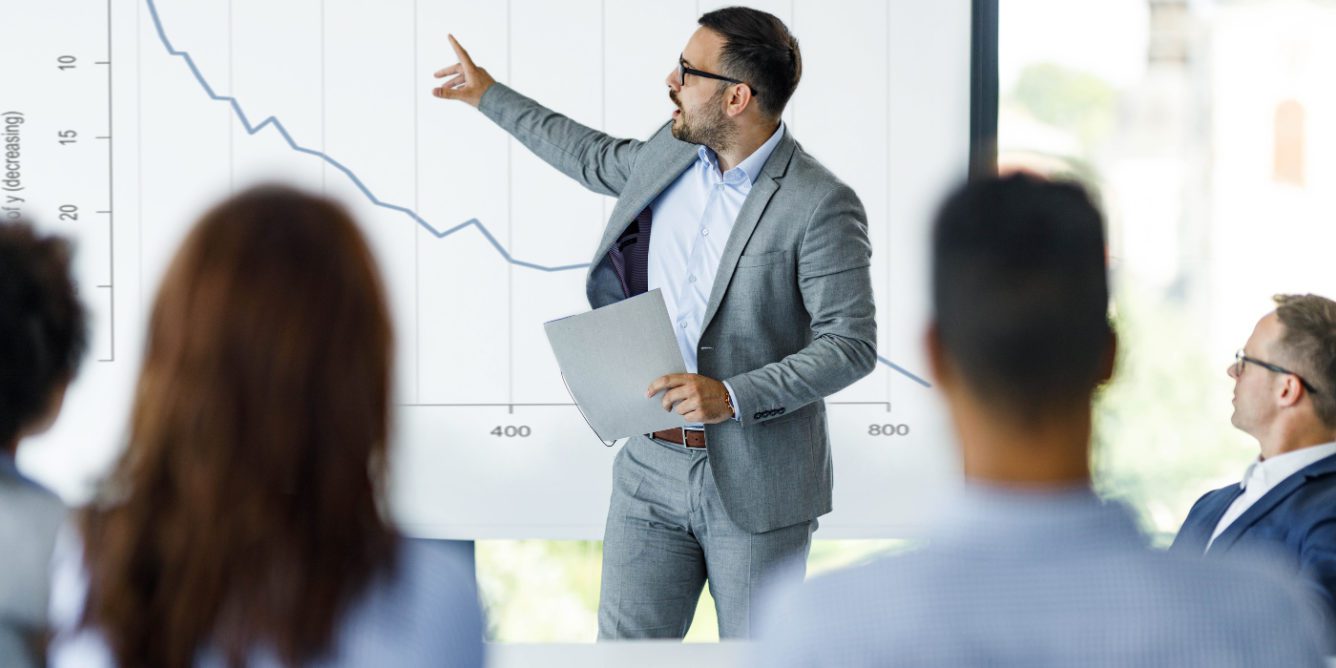 man pointing at chart