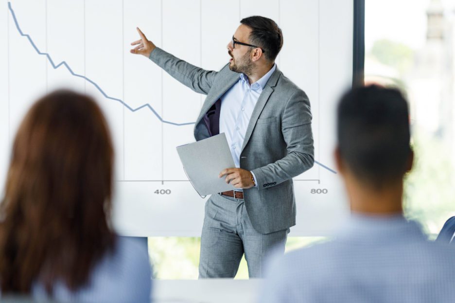 man pointing at chart